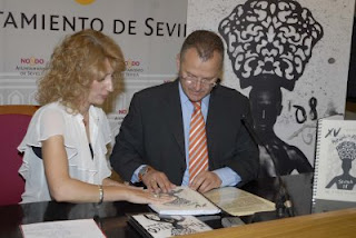 Patricio Cárceles muestra a Maribel Montaño el relieve de la portada del catálogo de la Bienal en braille