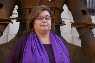 Primer plano de Dolores Rivero junto a una escultura ubicada en la Plaza Nueva de Sevilla