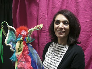 Loreto, sonriente, junto a una marioneta