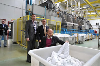 Raúl López cogiendo una de las toallas del contenedor