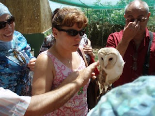 Una de las afiliadas tocando una de las aves de la reserva