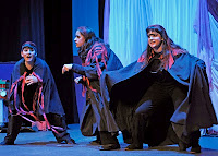 Actores de Menudo Trajín con sus capas abiertas sobre el escenario