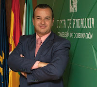 Foto oficial de Higinio Almagro con las banderas de Europa, España y Andalucía al fondo