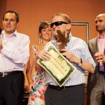 Imagen de uno de los finalistas posando con su diploma y placa